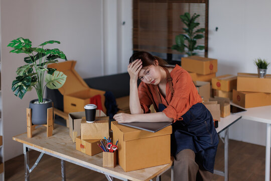 Small SME Business, Startup SME, Owner Entrepreneurs. Stressed sad Asian woman with unsuccess business online shopping crying and serious face unhappy mood.