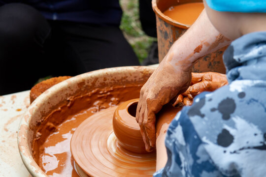 Pottery training. Rotating a clay pot on a machine. Hands knead clay. Making a clay pot..