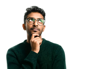 A thoughtful young man in a cozy sweater ponders ideas while holding his chin. He wears stylish glasses, embodying curiosity and contemplation.