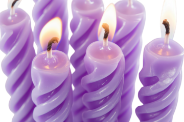 Group of purple spiral birthday candles with glowing flames isolated on transparent background