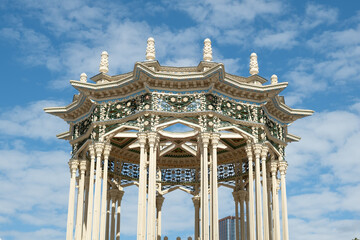 Close-up of decorative roof and carved columns at Uzbekistan pavilion in Moscow, featuring oriental architectural style and geometric patterns