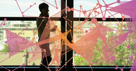Talking woman holding smartphone and gesturing by office window, with abstract network overlay