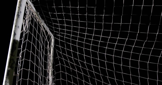 Fototapeta Framing white soccer goalpost with net standing on sports field at night, with chipped paint