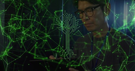 Mature Korean man wearing glasses examining tablet in dim server bay, with green network overlay