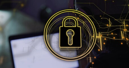 Displaying glowing golden padlock icon overlaying blurred laptop screen, with data flow graphics