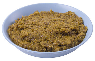  Isolated pesto sauce in a blue bowl, side view