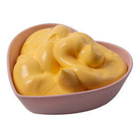 Isolated cheese sauce  in a heart shaped rosette on a white background, side view