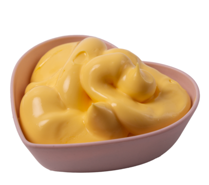 Isolated cheese sauce  in a heart shaped rosette on a white background, side view