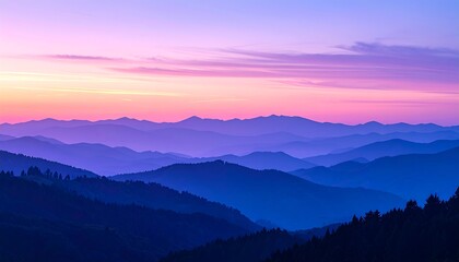 Obraz premium A breathtaking view of mountain ranges, painted in soft shades of purple and pink during a vibrant sunrise.
