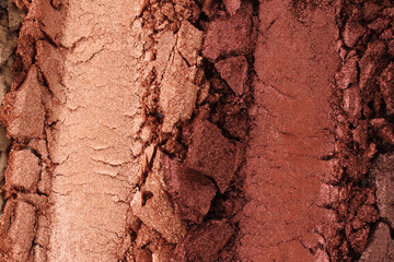 Broken and smashed make-up eyeshadow pallete, lay of brush strokes, close-up for background, top view. Sample cosmetics concept
