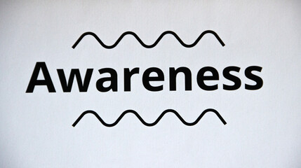 Extreme close up of the word 'awareness' on white paper sheet, isolated