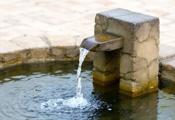Serene Stone Fountain: Water Flowing into Basin