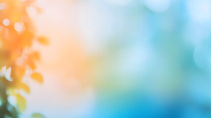 A soft-focus image showcases a blend of gentle orange and vibrant blue tones, highlighting bokeh effects and out-of-focus leaves and branches.