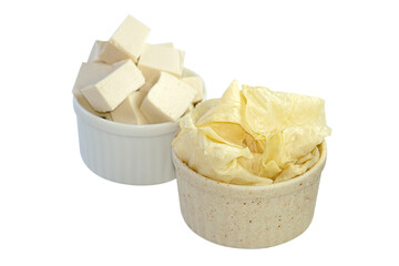 Tofu sheets and tofu in a cup placed on a white background.