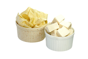 Tofu sheets and tofu in a cup placed on a white background.