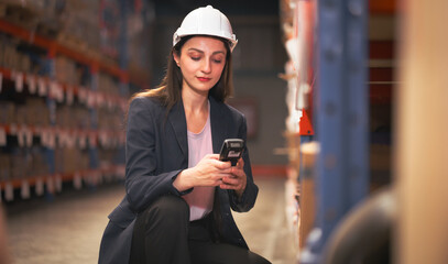 Distribution warehouse worker using digital scanner checking inventory on shelf. Female inventory manager supervisor or logistic engineer working at storage room in storehouse. Goods supply management