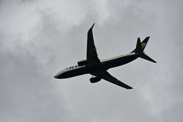Passenger airplane in blue sky seen from below
