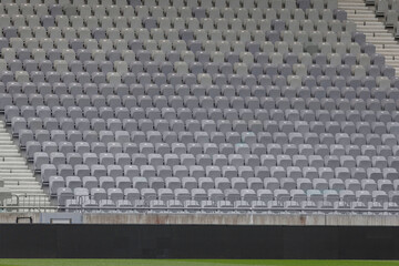 Vibrant turquoise and grey seating fills a soccer stadium, ready for fans to enjoy the game.