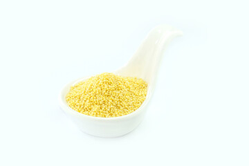 Millet in a White spoon-shaped cup on a white background.