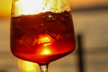 sunset aperitif in bardolino, refreshing drink with ice and citrus slice