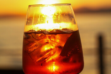 sunset aperitif in bardolino, refreshing drink with ice and citrus slice