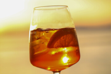 sunset aperitif in bardolino, refreshing drink with ice and citrus slice