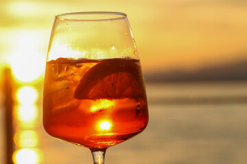 sunset aperitif in bardolino, refreshing drink with ice and citrus slice