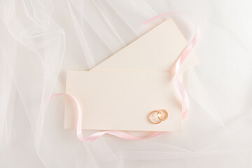 Elegant wedding rings on an ivory envelope