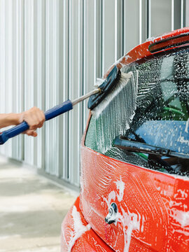Car cleaning with soapy brush for a shiny finish