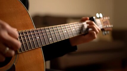 Person Plays Acoustic Guitar Chords in Living Room During Evening Practice Session