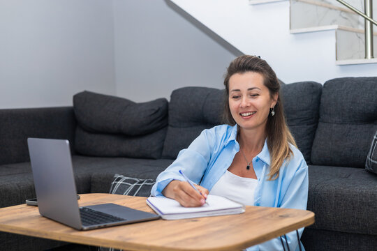 Woman working remotely on laptop at home