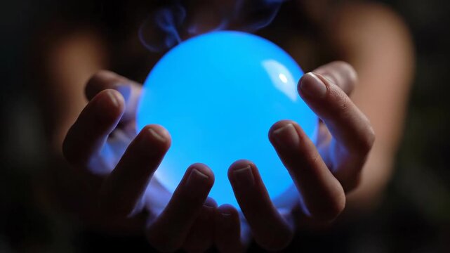 Hands Hold Glowing Blue Orb, Light Illuminates Fingers in Dark Ambience, Showcasing Mystic Power at Night