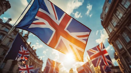 Union Jack flags waving in city street, sunlight