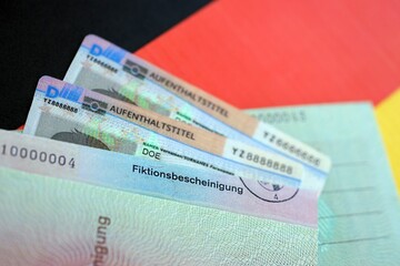 German Permanent resident card and temporary document lies on Germany flag