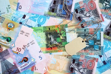 Kuwaiti dinar currency money bills and military token. The concept of army service