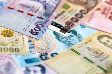 Thai baht currency money. The current banknotes lies on table in big amount