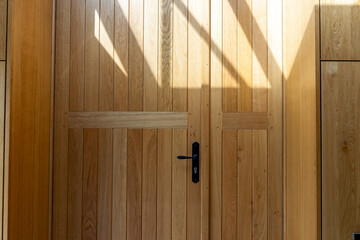 Gros plan sur une porte en bois massif, mettant en valeur la finition et le savoir-faire du...