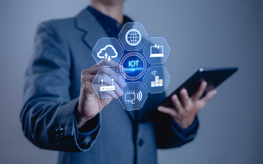 Businessman using digital interface with IoT icons representing smart technology, cloud computing, digital marketing, internet connectivity, wireless communication and future innovation concept.