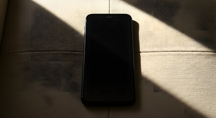 Black Smartphone on Beige Upholstered Surface