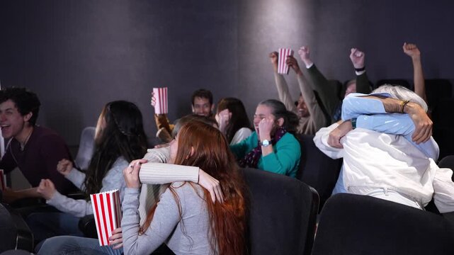 Multi panel slow motion video showcasing an enthusiastic movie theater audience cheering, hugging, and enjoying a match sport