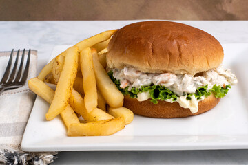 shrimp seafood salad sandwich with  french fries