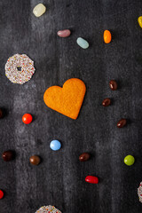 Various sweet food on black chalkboard background. Flat lay. Top view. Food concept.