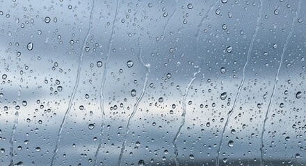 Raindrops on Glass with Sky Background