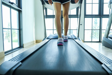 a woman in a blue workout outfit prepares to lift weights for exercise.
