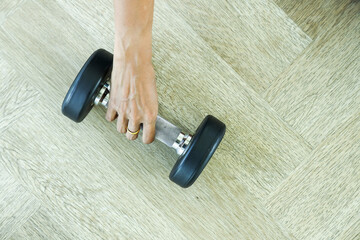 a woman in a blue workout outfit prepares to lift weights for exercise.