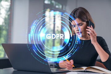 Pensive attractive beautiful businesswoman in formal wear working on laptop at office workplace in background. Concept of data protection information technology. lock icon hologram. talking phone.