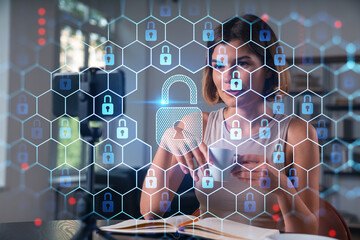 Happy woman is making video blog using smartphone on a tripod explaining with hands at office workplace. Concept of online stream, business education, conference call. Lock icons hologram