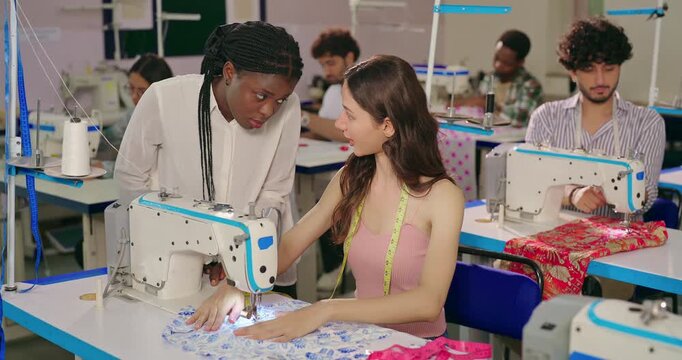 Indian young adult female wear tape around neck sitting indoor class room place woman learn sewing use craft clothe Teen girl student pupil do new course lady talk help teach stitch skill college day