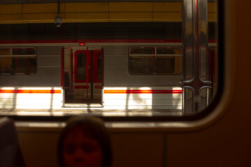 A woman is seated comfortably on a train, gazing thoughtfully out the window at the scenery passing by, lost in her own thoughts