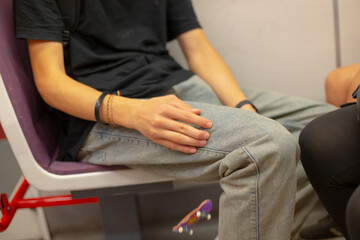 A man and a woman are comfortably seated on a bus, both crossing their legs as they engage in conversation while enjoying the ride